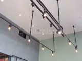 Steel tube and clamp fittings on roof of cafe with lights placed into them