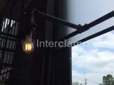 Black powder coated steel tube with light fitted in a cafe