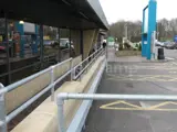 Pedestrian safety handrails fitted at a service station in England using Interclamp steel tube and fittings