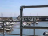 Safety handrail system fitting over looking a harbour front