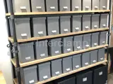 industrial wooden shelving made with Interclamp steel tube and tube clamp fittings. Plastic boxes on storage shelves