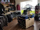 Clothing store stocking jackets and coats. Industrial interior by using Interclamp steel tube and fittings for the clothing rails