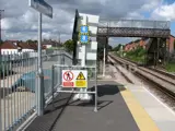railway station with Interclamp sign holders. Railway bridge in the distance